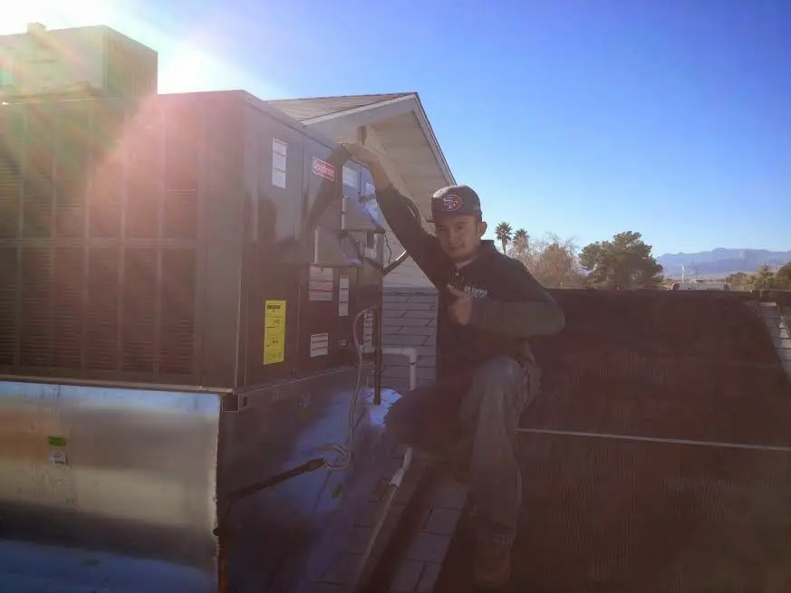 HVAC technician performing Boiler Repair on a rooftop unit in Marlow Heights